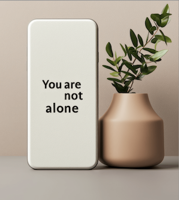 Phone displaying “you are not alone,” offering hope and support for recovery