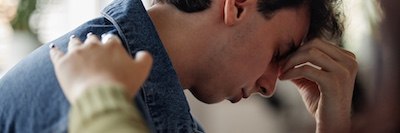 Young man appearing overwhelmed, representing mental health or addiction challenges