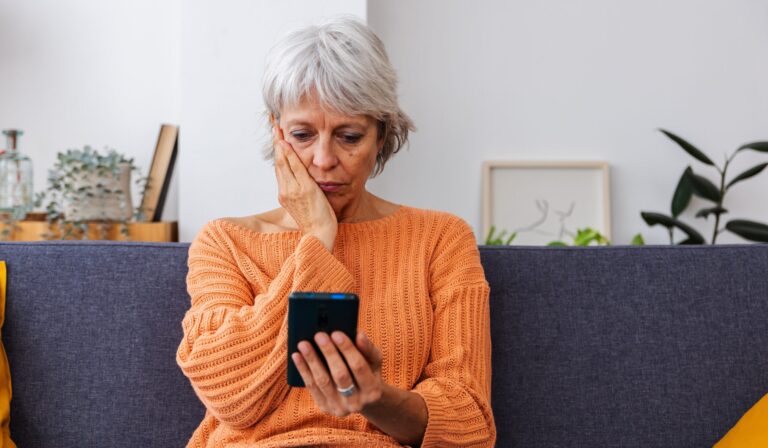 Stressed woman overwhelmed by a loved one’s addiction, reflecting the need for addiction coaching services